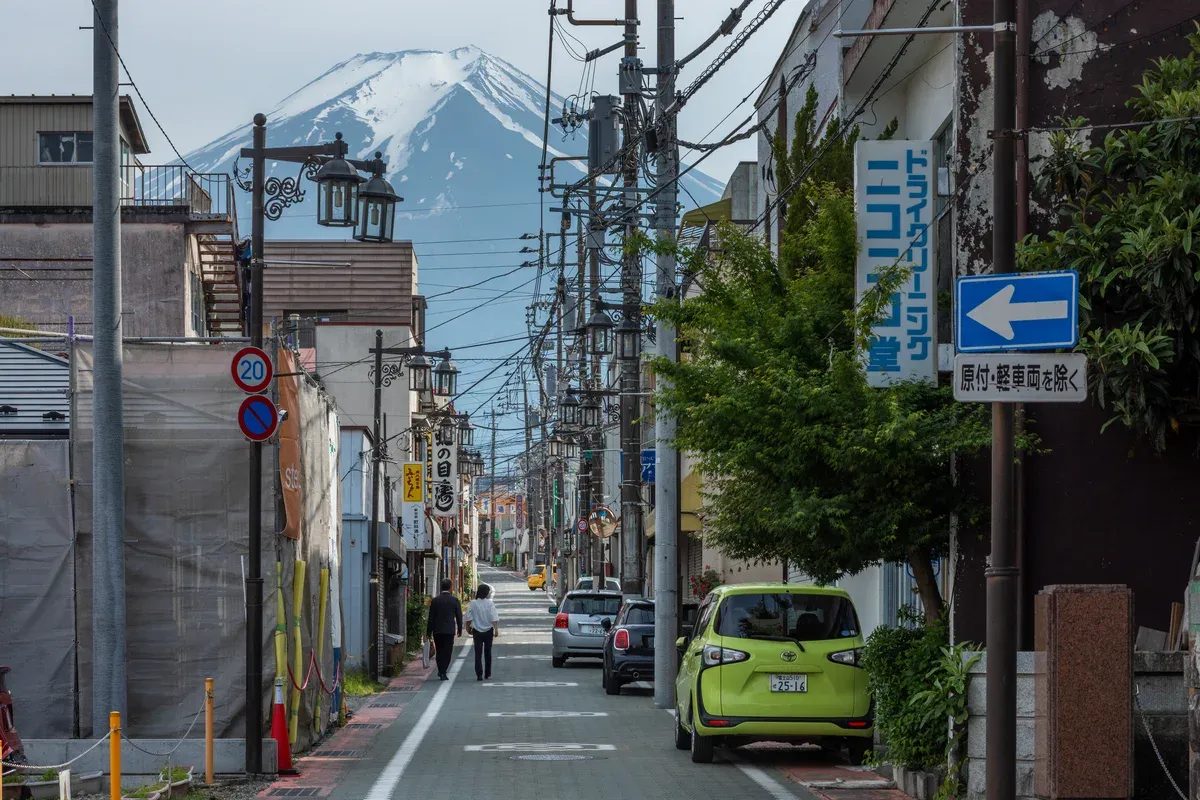 Fujiyoshida street leading toward snow-capped Mt Fuji on a Mt Fuji and Kamakura day tour from Tokyo