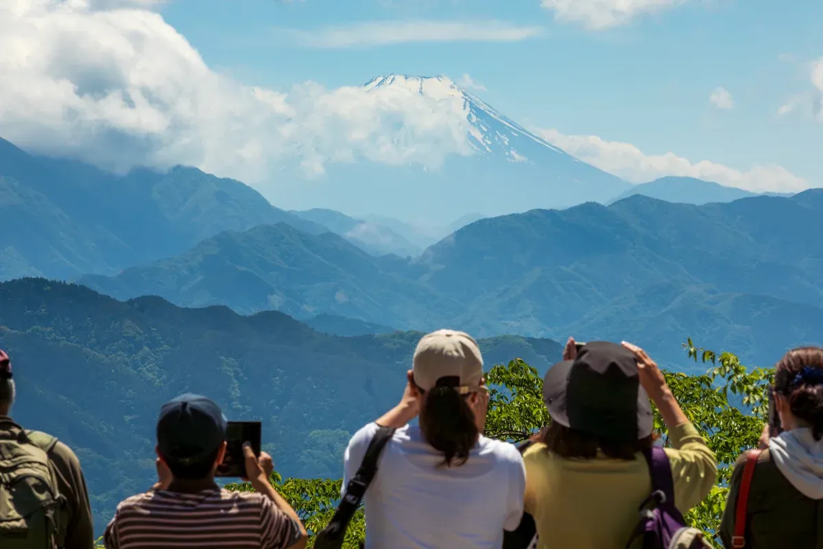 Hikers viewing Mt Fuji from Mount Takao on a day trip from Tokyo
